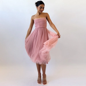 Detailed view of the layered pink mesh hem on a sleeveless corset party midi dress