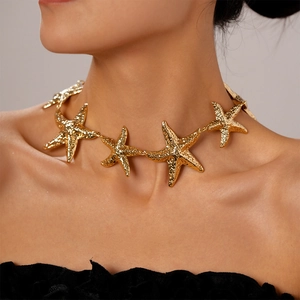 Detailed close-up of a gold starfish choker necklace showing metallic textures on a model