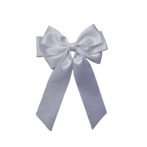 Detail of elegant white satin multi-layer bow hair clip with long flowing ribbons