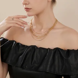 Chic multi-layer gold plated snake bone chain necklace on a model for minimalist style