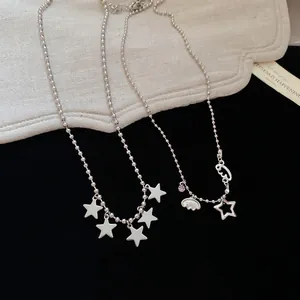 Silver bead chain necklace with five-pointed stars and cloud pendant on contrast background