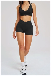 Detail eines schwarzen Yoga-Sets mit Sport-BH und High-Waist-Shorts mit praktischen Seitentaschen