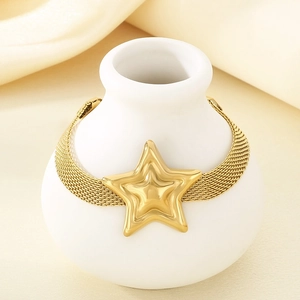 Gold stainless steel mesh band bracelet with a layered star charm on a white stand