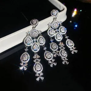 Elegant silver tassel earrings with zircon waterdrop charms on a black jewelry box