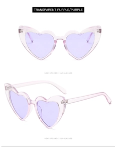 Detail view of heart-shaped transparent purple sunglasses with a dual-angle perspective