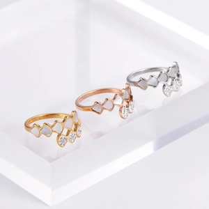 Three elegant rings in gold, rose gold and silver finish on display with heart patterns