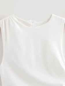 Detail shot of white sleeveless dress showing the neckline and hidden back zipper