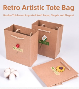 Detail of vintage kraft paper gift bag with braided rope handle and 3D floral sticker