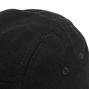 Close-up of black cotton twill baseball cap showing precise stitching and embroidered eyelets
