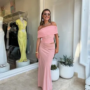 Detail of pink off-shoulder pleated top with matching high-waisted silk-like maxi skirt