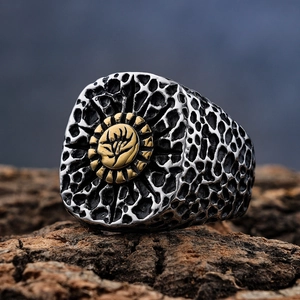 Retro punk skull ring in silver honeycomb texture with gold tree relief on wood