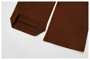 Detailed macro view of dark brown sweatpants showing hem stitching and soft terry lining