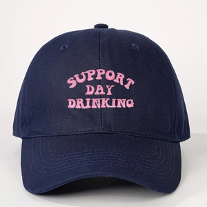 Close-up of pink Support Day Drinking embroidery on navy blue cotton baseball cap
