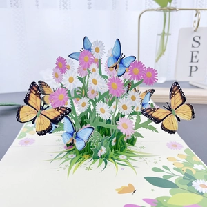 3D greeting card featuring blue butterflies, monarch butterflies, and colorful daisies