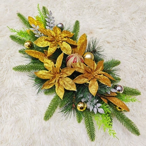 Christmas staircase garland with golden poinsettia flowers and decorative ornaments