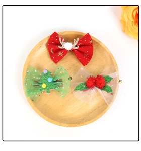 Detail of Christmas bow hair clips with glitter reindeer antlers and mesh netting