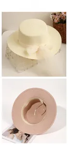 Detailed interior view showing adjustable straps and pearl lace bow on straw hat
