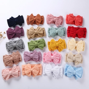 Set of 20 nylon baby headbands with large textured bows in various pastel colors