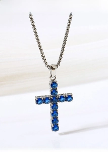 Macro shot of titanium steel cross pendant necklace with sparkling blue zircon inlay