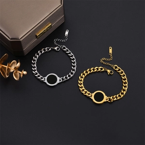Gold and silver chunky Cuban chain bracelets with black disc charm and jewelry box