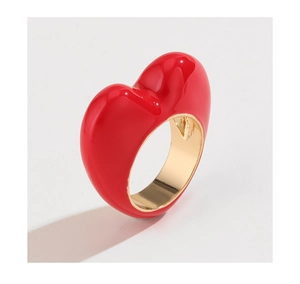 Detailed top view of a gold fashion ring featuring a large red enamel 3D heart centerpiece