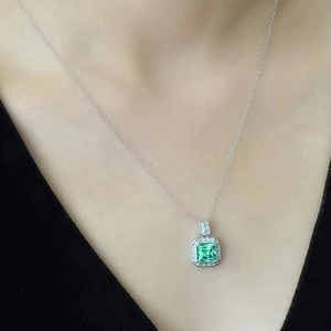 Elegant square emerald pendant necklace with halo diamond border on silver chain