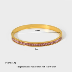 Detail showing 58mm diameter and 5mm width of a gold zirconia clasp bangle bracelet