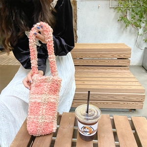 Close-up of pink and beige checkered plush tote bag with soft sherpa fleece texture
