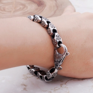 Vintage stainless steel chunky bracelet for men featuring ornate floral carvings on links