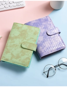 Flat lay of A6 macaron binders in green and purple crocodile leather texture with pen