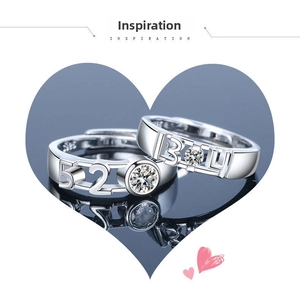 Macro detail of silver couple rings engraved with 520 and 1314 on a black mirror