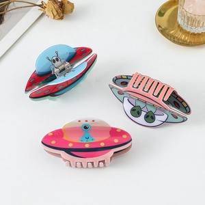 Three colorful UFO and alien hair claws in pink, blue, and purple set on white background