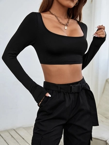 Detail of square neckline and high-stretch knitted fabric on black cropped long sleeve top