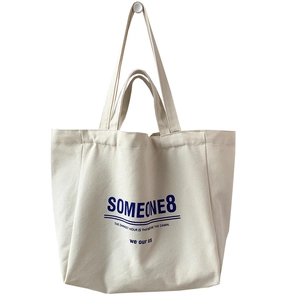 Minimalist off-white large canvas tote bag with blue lettering and shoulder straps