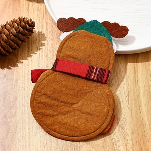 Detail of Christmas cutlery holders with felt fabric textures and holiday scene