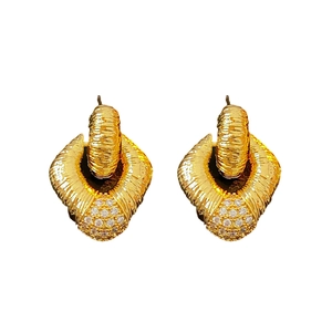 Golden diamond-textured metal earrings with clear gemstones on a clean white backdrop