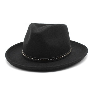 Detail of black wool fedora featuring a leather band with gold stud embellishments