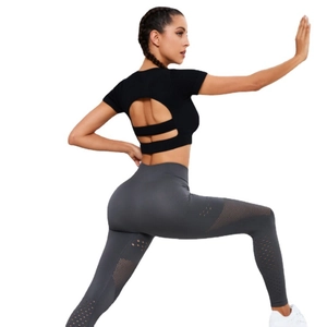 Two-piece yoga set with open back black short sleeve top and gray mesh leggings