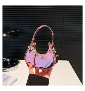 Detail view of pink laser metallic mirror handbag with gold zipper and semi-circle handle
