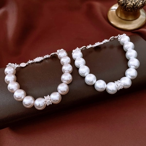 Macro detail of pearl bracelets featuring square-cut zircons and S925 silver clasp