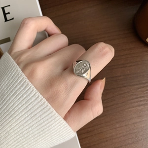 Close-up of vintage 925 sterling silver signet ring with sunflower engraving