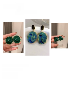 Macro detail of vintage style green enamel geometric earrings with gold plating