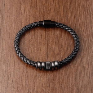 Men's minimalist black braided leather bracelet with stainless steel beads on wood