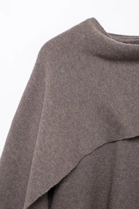 Close-up of brown knit fabric texture on shoulder and neckline of a winter sweater