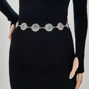 Detail of silver bohemian waist chain with engraved concho discs and turquoise stones