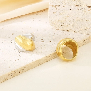 Thick 18K gold plated stainless steel twisted rings in gold and silver set on stone