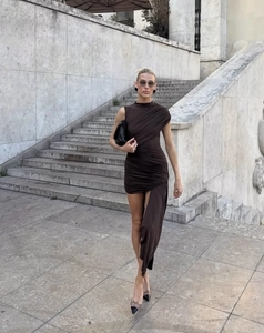 Close-up of deep brown asymmetric dress featuring elegant draping and pleated fabric detail