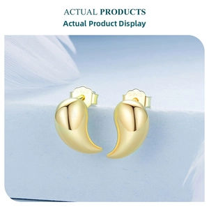 Detailed view of curved S925 sterling silver gold earrings with hallmark engraving