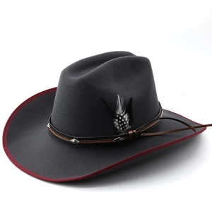 Close-up of grey wool felt cowboy hat featuring red trim and feather accent on band