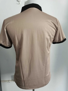 Rear view of men's khaki polo shirt with contrast black ribbed collar and sleeve cuffs